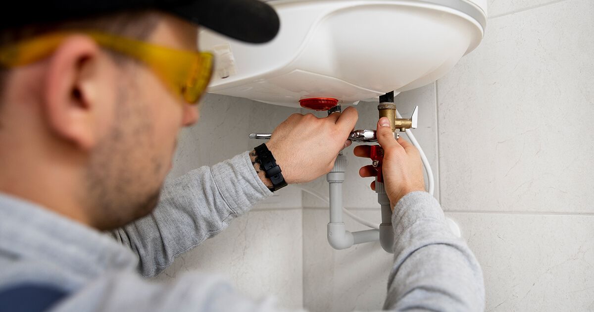 HVAC technician inspecting a water heater.