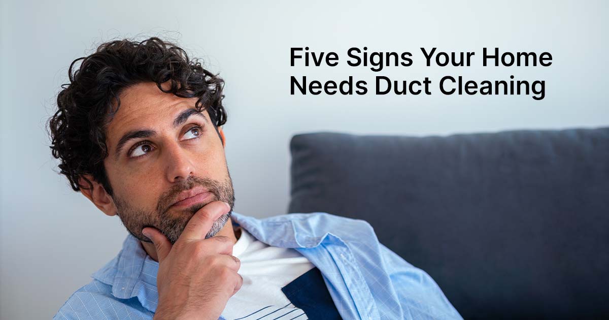 Man looking upwards while sitting on couch.