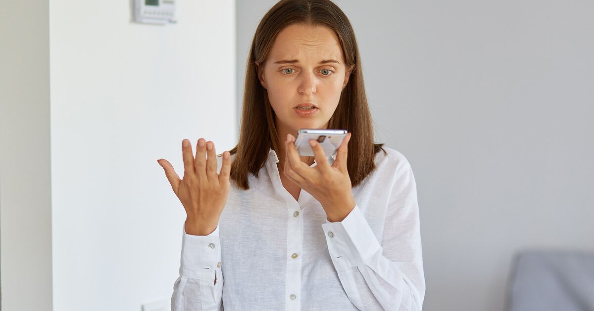 Woman on phone call looking frustrated.